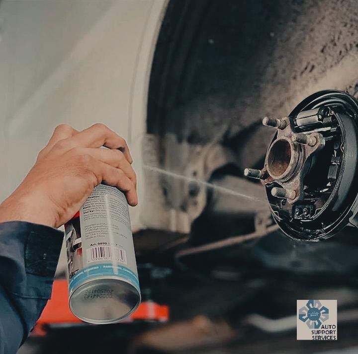 Close-up of work on a vehicle brake assembly